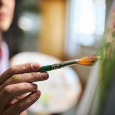 photo d''un peintre tenant un pinceau couleur verte