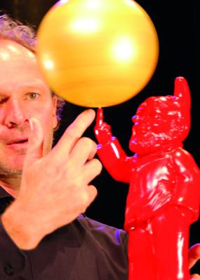 Un homme fait tourner un ballon sur son doigt