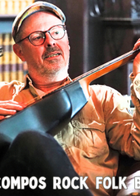 Un homme est assis sur un fauteuil et joue de la guitare